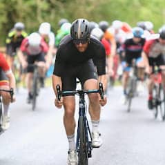 bicycle rider wearing black riding in a cycle race.
